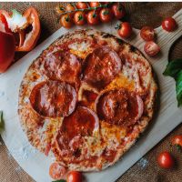 Diavola Pizza with spicy soppressata, red pepper pesto, mozzarella and tomato sauce